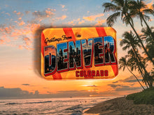 Load image into Gallery viewer, Vintage style post card dog id tag with 'Greetings from Denver, Colorado' over a beach sunset scene.
